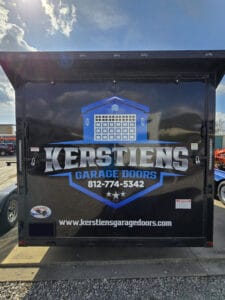 Truck with Kerstiens Garage Doors logo, phone number, and website on a sunny day.